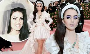No impersonators were needed 49 years ago on this day, when heartthrob elvis presley married priscilla beaulieu in the ultimate las vegas wedding. Lily Collins Wows In Ruffled White Gown As She Channels Priscilla Presley S Wedding Day Daily Mail Online