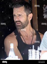 EXCLUSIVE!! Openly gay actor Rupert Everett shows off his beard as he  relaxes at an outdoor cafe with friends in Soho during the 2010 London Gay  Pride Parade. London, UK. 07/03/10 Stock
