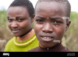 Penina Kgenda (brown jumper) and Josephine Kendi, both 13, both AIDS  orphans, have been friends since birth. Penina lives with her grandmother  and Jo Stock Photo