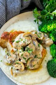 A Pork Chop With Mushroom Sauce Served On Mashed Potatoes With A Side Of Broccoli Pork Chop Side Dishes Pork Chop Dinner Mushroom Pork Chops