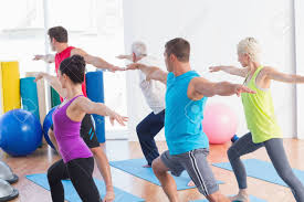 20 yoga poses for beginners. Fit Men And Women Doing Warrior Pose In Yoga Class Stock Photo Picture And Royalty Free Image Image 36413109