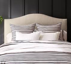 Expertly crafted, this headboard is made of solid wood, reinforced with veneer and detailed with decorative molding. Raleigh Curved Upholstered Headboard Pottery Barn