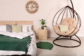 This steel hanging chair allows you to gently sway as you sit back and relax. Modern Bedroom Interior With Comfortable Hanging Chair Stylish Design Stock Photo Picture And Royalty Free Image Image 119377157