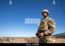 A Mexican soldier stands guard in front of a charred auto in front of the  Piedras Negras City Hall and jail, Dec. 31, 1984, after supporters of a  defeated mayoral candidate set