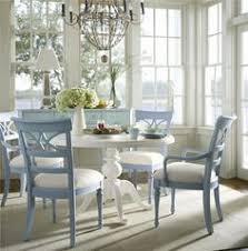 This Round Pedestal Table And Cutout Back Chairs Dining Set Has An Easy Going Coastal Cottage Inspired Design That Fe Home Pedestal Dining Table House Interior