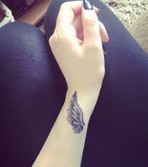 50 Eye Catching Wrist Tattoo Ideas Cuded Wing Tattoos On Wrist Wings Tattoo Wrist Tattoos For Women