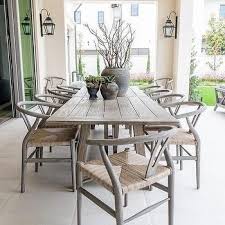 Round Gray Teak Slatted Top Outdoor Dining Table With Rattan Chairs Cottage Deck Patio In 2020 Outdoor Dining Table White Outdoor Table Dining Table Design