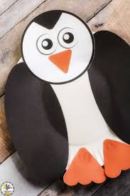 The tummy and eyes are white and the the beak and feet are orange . Paper Plate Penguin Craft For Kids