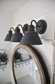 Build this farmhouse vanity with free instructions at the link. Diy Farmhouse Bathroom Vanity Light Fixture Light Fixtures Bathroom Vanity Farmhouse Bathroom Vanity Vanity Light Fixtures