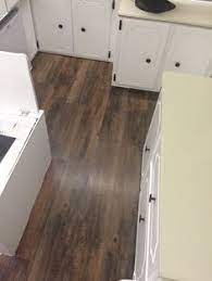 The peel and stick vinyl tile is very thin. Pop Up Camper Floors This Peel Stick Vinyl Plank Flooring Is From Lowes Feels Like Handscraped H Camper Flooring Handscraped Hardwood Vinyl Plank Flooring