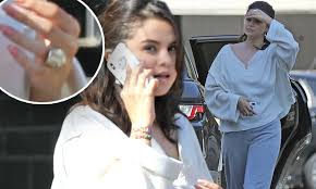 Selena gomez unveils new cross tattoo. Selena Gomez Wears A Large Ring On Her Wedding Finger Daily Mail Online