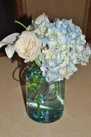 Ball Jars For Flower Centerpieces Are Simple And Elegant You Can Also Spray Paint T Boy Baby Shower Centerpieces Baby Shower Flowers Baby Shower Centerpieces
