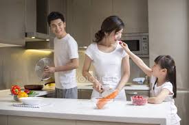 Taken on november 24, 2011 Chinese Daughter Feeding Mother While Cooking In Kitchen Girl Vegetables Stock Photo 182392418