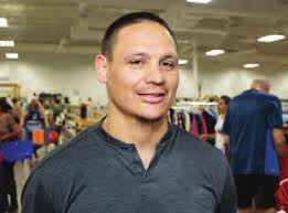 Guy Chats with White Elephant Shoppers