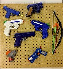 With the nylon clips pushed closest to the outside of each corner, use a marker to mark the hole location for the wall anchors. Nerf Toy Gun Hanging Kit Pegboard Fixings And Hanging Pegs 800x400mm Amazon Co Uk Diy Tools