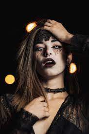 About 400 brands available in stock. Unemotional Female In Black Dress And With Scary Makeup Standing In White Contact Lenses On Halloween In Darkness While Looking At Camera Stockphoto