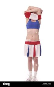 Beautiful young woman undressing from her cheerleader kit Stock Photo -  Alamy