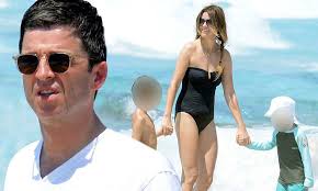 Noel Gallagher plays with children and wife Sara McDonald in the sea in  Spain