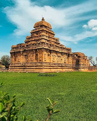 The front view of Mallikarjuna Temple in Pattadakal, also known as Trilokeshwara, shows its partly broken Nandimandapa. Built by Queen Trilokamahadevi around the same time as Virupaksha Temple, it shares similarities but