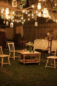 Garden Party At Night Lanterns Hang From Tree Branches And Rustic Furniture With Flowers And Lace T Vintage Garden Decor Shabby Chic Garden Backyard Lighting