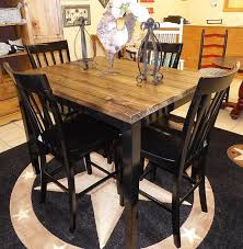This breakfast table features a smooth rectangular top, tapered legs, and ample storage shelves perfect for apartments or small kitchen areas. Farm House Pub Table With Four Chairs Repurposed Table Set Rustic Pub Table Set Local Pick Up Only On Dining Table Pub Table And Chairs Dining Table Setting