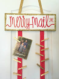 Making christmas place card holders for the table is as simple as tying two sprigs of holly together and placing a card between the berries. Lindsay S Sweet World Diy Christmas Card Holder