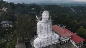 Premium stock video - Beautiful bahirawakanda vihara buddha statue between  the green hills of kandy with in the background the high mountain peaks  from the green nature of sri lanka