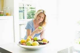 Nestle your fruit medley into one of these vessels. Smiling Woman At Home Taking Apple From Fruit Bowl Stockphoto