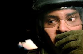 U.S. Marine Lance CPL. Trymain Rivero, Marine Heavy Helicoper Squadron,  464th Detachment Alpha, talks through his headset during a take off and  landing operation aboard a CH-53 Sea Stallion helicopter at Camp