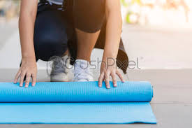Standard yoga mats are 1/8 of an inch thick, but go up to 1/4 of an inch. Shot Of Attractive Asian Girls Rolling Yoga Mat Or Blue Stock Photo Crushpixel