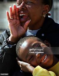 Myles Mason of Placentia, snuggles with his mom, Regina Mason, as she...  News Photo