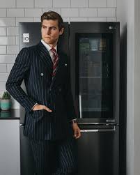 Black And White Striped Suit Jacket Sam Wines In A Double Breasted Black White Pinstripe Suit White Collared Shirt Red White Striped Tie Black Leather Band Watch Suit Menswear Gentlemen Abiti