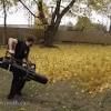 Worker on a street in autumn collects leaves with a leaf blower. 1