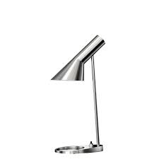 The tapered lampshade, coloured on the inside in white, serves to bundle and reflect the light. Louis Poulsen Louis Poulsen Aj Table Mini Lamp Stainless Steel