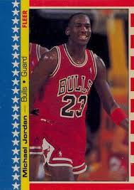 It features a diagonal image of jordan with a basketball clutched in one hand, with a gold background and a multicolored border. Michael Jordan Rookie Cards List Top 1980s Gallery Best Mj Rc