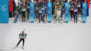 The character has the same colors as the olympic rings, including red, yellow, green, black, and blue. French Master Fourcade Completes Historic Biathlon Pursuit Defence Olympic News