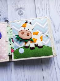 In The Book Of 8 Pages Mastering A Textile Book Your Baby Actively Develops Fine Motor Skills Learns To Speak And Ex Quiet Book Soft Book Diy Quiet Books