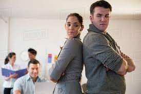 Business People Standing Back To Back In Office Stock Photo Dissolve