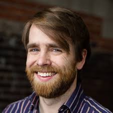 PERI faculty members (from left) Steven Sprick Schuster and Daniel Smith  celebrate PERI Fellow Gabriel Benzecry's successful def