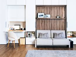 Beds in studio apartments can be tricky, but there are a few clever hacks that can quite literally in this airy bedroom, the bed and side table are the only real furniture, while a simple table lamp is styled. Murphy Beds Are Back And Better Than Ever Thanks To These Ward Village Studios
