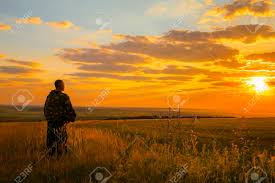 Human And Nature A European Man Stands In A Field Looking Into The Distance To The