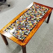 Yes, it is a resin poured over bottle caps on an old coffee table. Beer Cap Coffee Table Beer Cap Crafts Beer Cap Table Bottle Cap Table