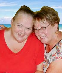 Could someone please remove the people in the background. And put in a nice  background. Recently lost a beloved sister. Thanking you in advance for  your help.