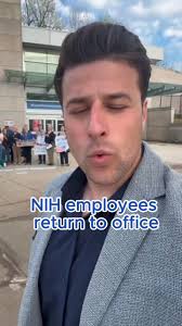 NIH employees are met with support, song as they return to offices