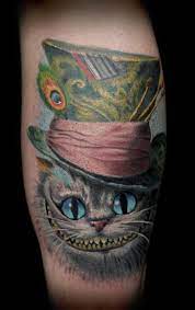 30 Cheshire Cat Tattoo Ideas To Try In February 2021 Cheshire Cat Tattoo Cat Tattoo Designs Wonderland Tattoo