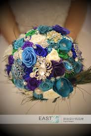 There are a variety of seasonal flowers available during this time. Bride Creative Peacock Feather Bouquet New Arrival Romantic Wedding Sky Blue Purple Flowers Brooch Bridal Bride S Bouquets Camellia Vines