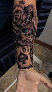 A jester skull tattoos with red rose and a bird and a mike. 90 Best Skull Tattoo Design Pictures And Meaning