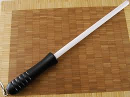 Try heating it up in some very hot water, then clean the usual way using a glove if you need one. Idahone Fine Ceramic Rod 12 Black
