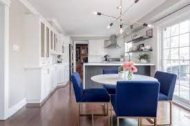 Cobalt Blue Dining Chairs Surround A Round White Marble Top Dining Table With A Black Tulip Bas White Round Dining Table Blue Dining Chair Velvet Dining Chairs