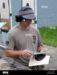 Fort Benning, GA—Staff Sgt. Greg Markowski, U.S. Army Marksmanship Unit  (USMAU) Service Pistol shooter/instructor, goes over his scorecard during  the 2017 Interservice Pistol Championship held at Phillips Range June  12-16. Markowski won